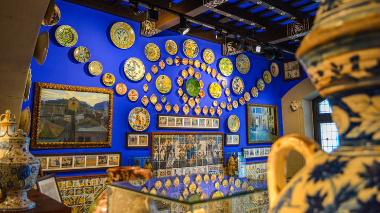 La salle d'exposition élaborée de Museu del Cau Ferrat avec des peintures et des assiettes décoratives sur le mur