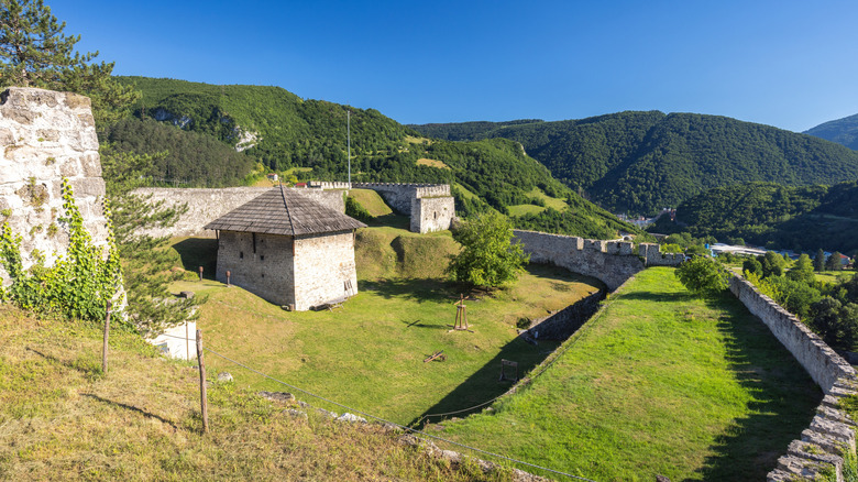 La forteresse médiévale de Jajce avec des collines vertes en arrière-plan