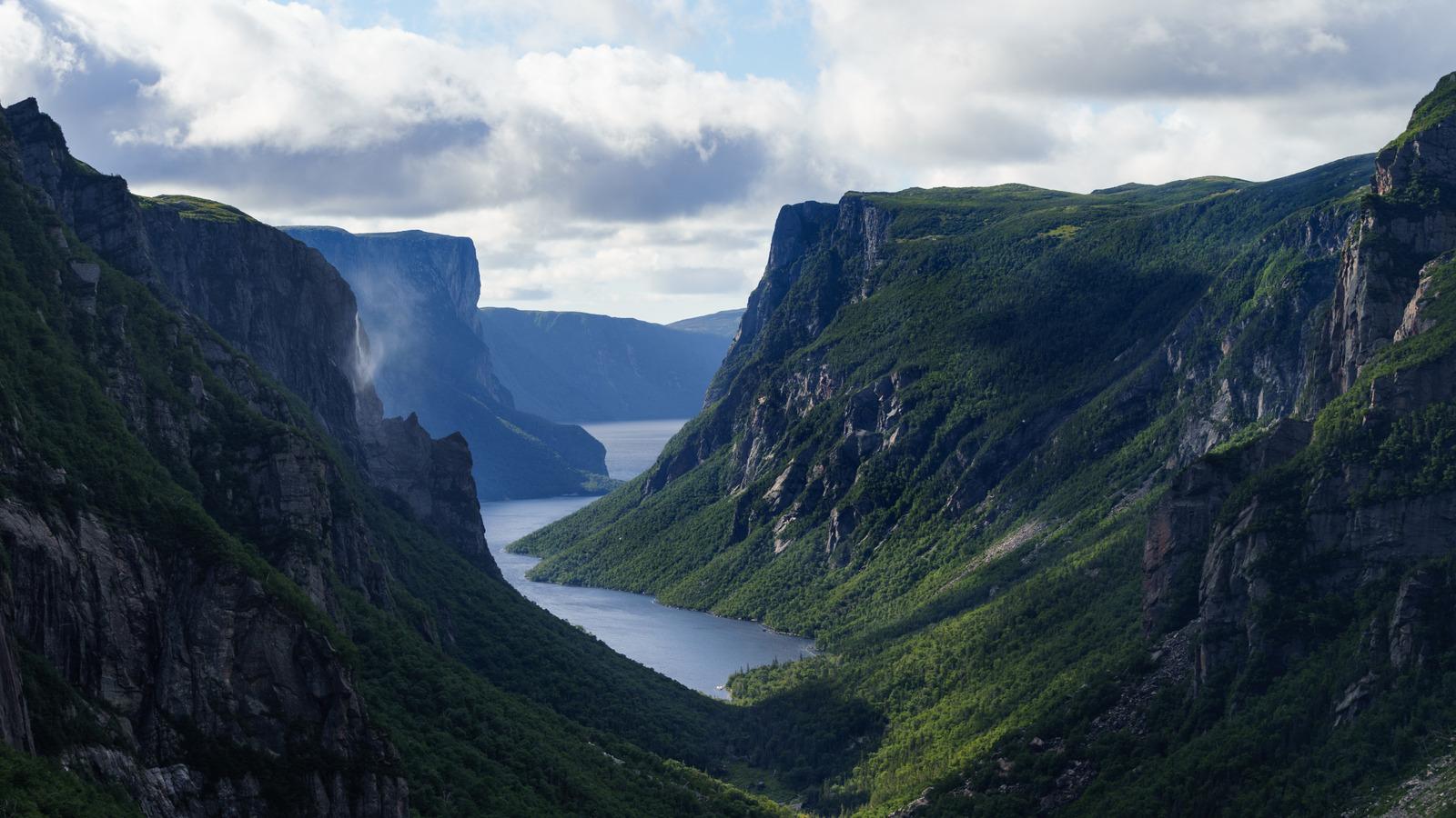 Le lac surréaliste du Canada est un spectacle à couper le souffle du parc national avec des falaises en plein essor et des eaux brumeuses