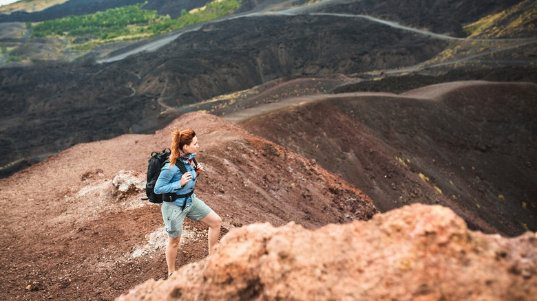 La femme regarde au loin en faisant de la randonnée dans le mont Etna